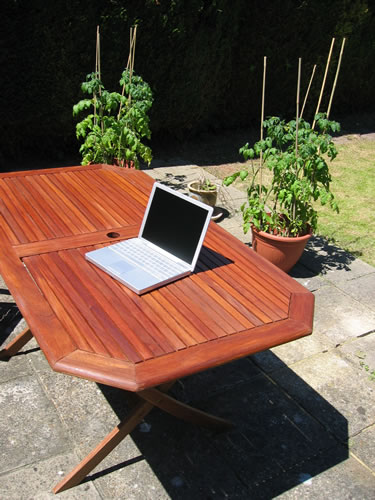 A picture of my Apple PowerBook on my garden table