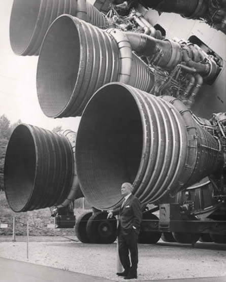 A picture of Werner von Braun stood next to a horizontal Saturn V rocket
